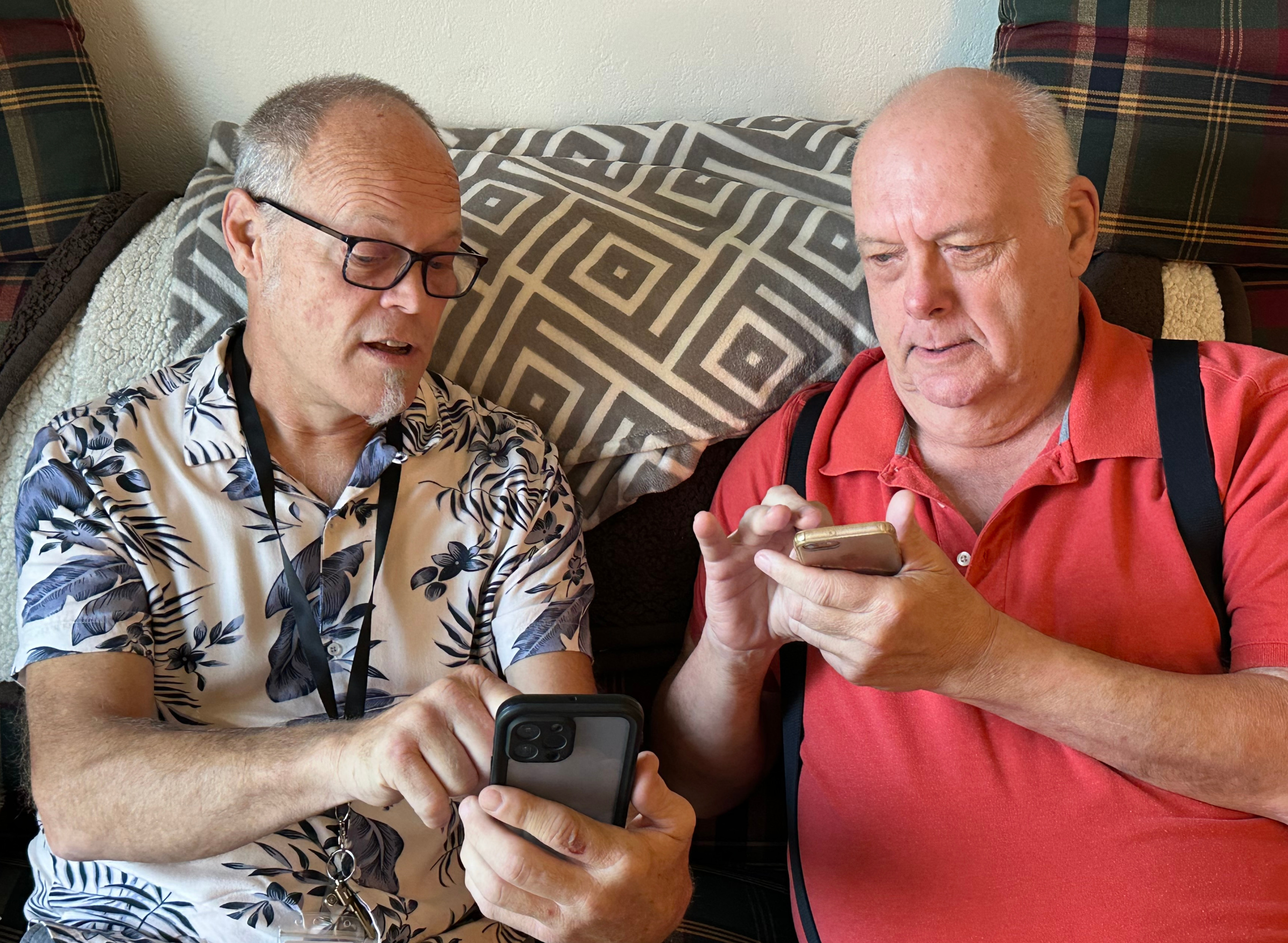 Two men on their phones